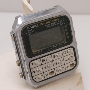 May include: A set of three ceramic mugs with a speckled, matte finish. The mugs are in shades of cream, light gray, and dark gray. Each mug has a simple, minimalist design, perfect for coffee or tea.