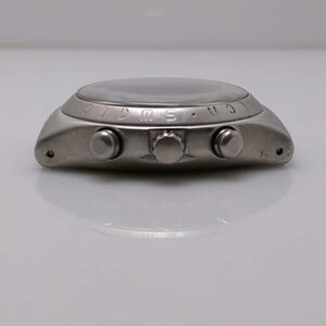 May include: A silver-toned wristwatch with a round face and three buttons on the side. The watch has a dark face and a metallic band. The watch is a classic design, suitable for everyday wear.