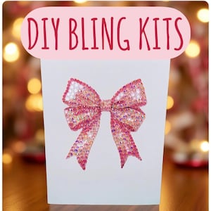 May include: A white DIY Bling Kit with a large pink sequined bow design. The bow is centered on the front of the kit and has a detailed, sparkling appearance. The words "DIY BLING KITS" are in pink script above the bow.