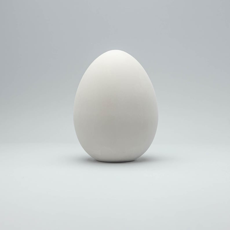 May include: A white egg on a white background.