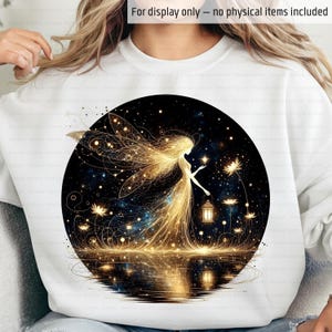 May include: White sweatshirt featuring a circular graphic of a golden fairy with outstretched wings, holding a lantern. The fairy is set against a dark blue starry background with a reflective water surface. The text "For display only - no physical items included" is at the top.