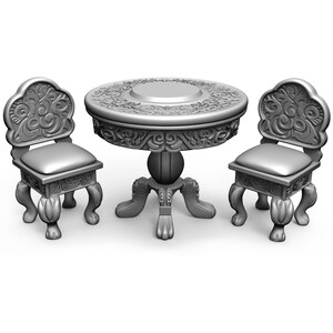 May include: A silver, ornate, three-legged table with a round top and two matching chairs. The table and chairs have intricate carvings and a distressed finish.