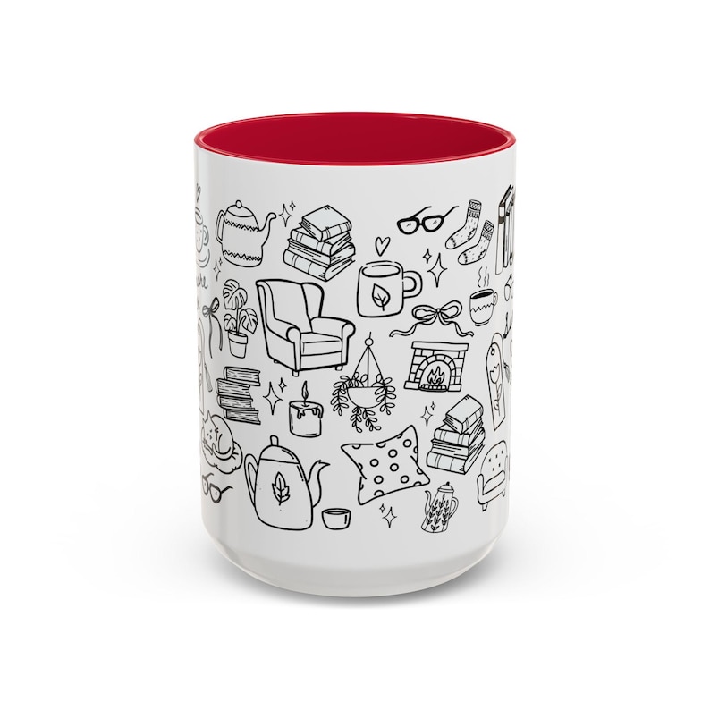 May include: White ceramic mug with a red interior, decorated with black line drawings of cosy items such as books, teapots, a fireplace, and an armchair. The mug is designed for hot drinks.