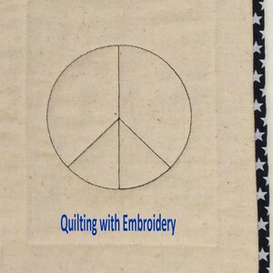 May include: A quilted square with a peace symbol in the center, outlined in black. The background is a light beige color. The border is navy blue with white stars. The text "Quilting with Embroidery" is in blue.