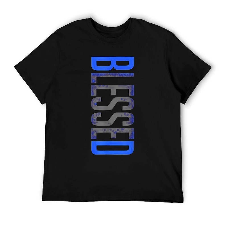 May include: Black t-shirt with the word "BLESSED" printed vertically in a blue and gray design. The text has a textured appearance, and the shirt is made of a soft material.