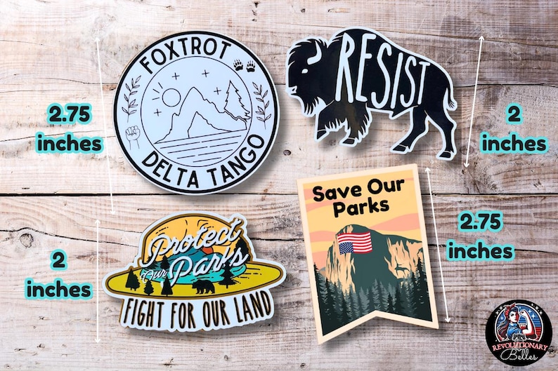 May include: Four vinyl stickers with different designs. The first sticker is blue and white with the text "FOXTROT DELTA TANGO". The second sticker is black and white with the text "RESIST". The third sticker is yellow and green with the text "Protect Our Parks Fight For Our Land". The fourth sticker is orange and green with the text "Save Our Parks".