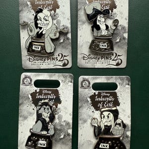 May include: Four Disney Inkwells of Evil limited edition pins. Each pin features a different villain character design, set on a grey card with the Disney Pins 25th Anniversary logo. The pins are in a black inkwell.
