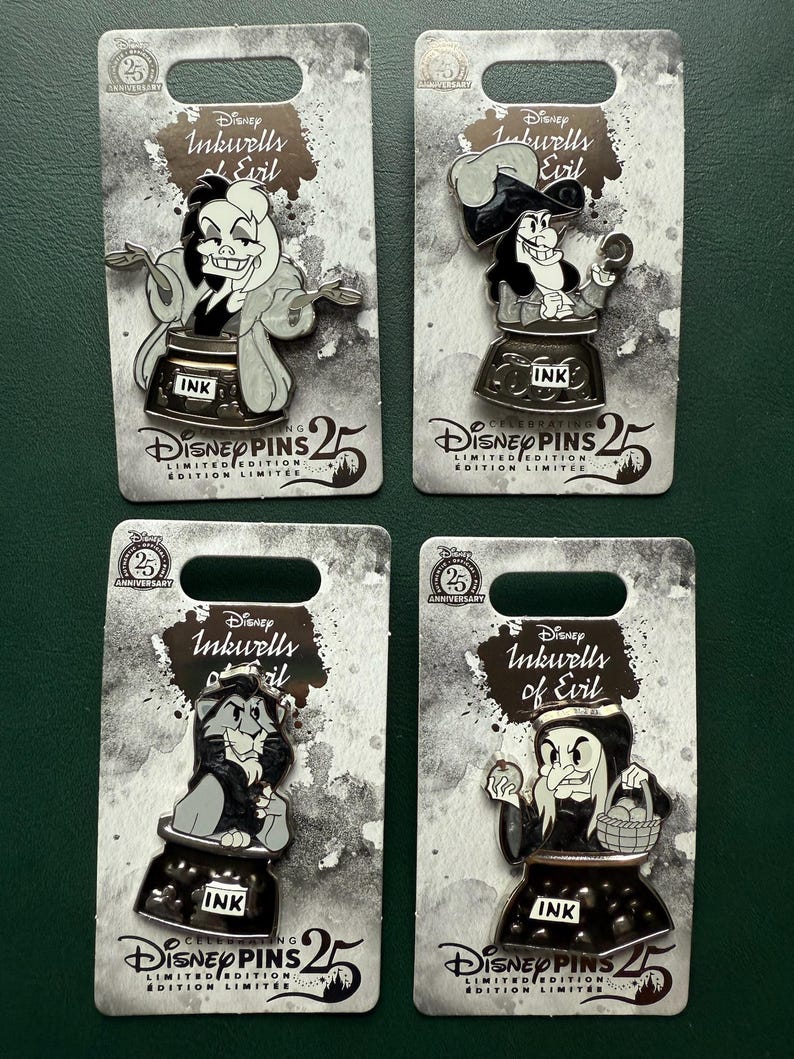 May include: Four Disney Inkwells of Evil limited edition pins. Each pin features a different villain character design, set on a grey card with the Disney Pins 25th Anniversary logo. The pins are in a black inkwell.