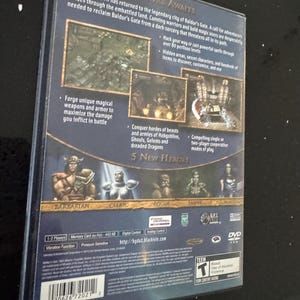 May include: Back cover of a PlayStation 2 game case for Baldur's Gate: Dark Alliance II. The case is blue and features a picture of the five playable characters: Barbarian, Cleric, Rogue, Monk, and  Tiefling. The game's title is in a gold font and the text "A New Adventure Awaits" is in a white font. The game's ESRB rating is Teen and the game is rated for Blood, Use of Alcohol, and Violence.