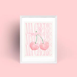 May include: A white framed print with a pink background and the text "Ma Cherie" repeated multiple times. Two pink cherries with a pink ribbon are in the center of the print.