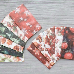 May include: A collection of rectangular paper envelopes featuring various holiday-themed prints, including white snowflakes on red, green pine trees, gingerbread cookies, poinsettia flowers, and red Christmas ornaments on a dark background.