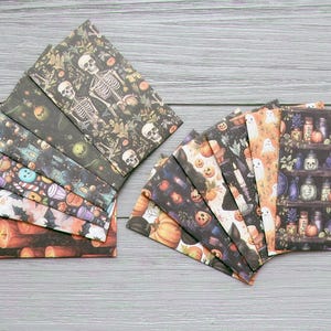 May include: A selection of Halloween-themed envelopes. The designs include skeletons, pumpkins, ghosts, and potion bottles. The colour scheme features black, orange, purple, and white, creating a festive and eerie aesthetic, perfect for seasonal correspondence.