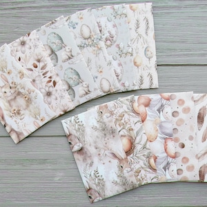 May include: A collection of rectangular paper sheets featuring various Easter-themed patterns in soft neutral tones. Designs include illustrations of rabbits, decorated eggs, floral arrangements, feathers, polka dots, and a brown plaid pattern.