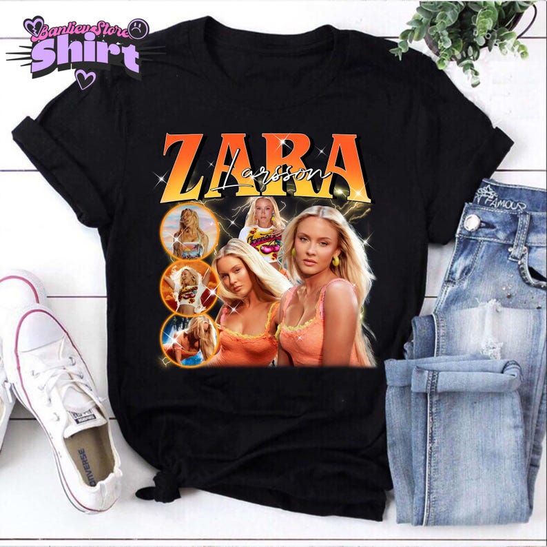 May include: Black t-shirt featuring a graphic of Zara Larsson with an orange and yellow gradient text design. The design includes multiple images of the singer. The shirt is paired with blue jeans and white sneakers.