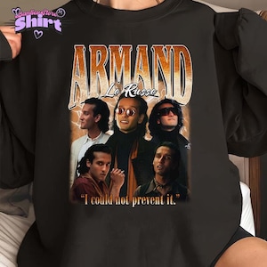 Op de afbeelding: Zwart sweatshirt met een vintage ontwerp. De afbeelding toont de naam "ARMAND Le Russe" in oranje, met meerdere afbeeldingen van een man. De quote "I could not prevent it." is ook opgenomen.