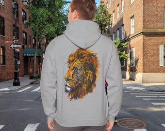 May include: A gray hoodie featuring a detailed lion's head graphic on the back. The lion's mane is rendered in shades of orange, brown, and yellow. The hoodie has a drawstring hood and a kangaroo pocket.