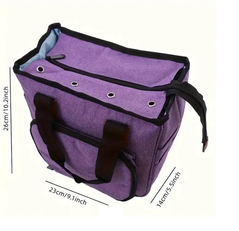 May include: A purple tote bag with black straps and a zipper closure. The bag has a small pocket on the front and measures 26cm/10.2 inches tall, 23cm/9.1 inches wide, and 14cm/5.5 inches deep.