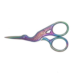 May include: A pair of iridescent rainbow-coloured scissors with a bird design. The scissors have a small hole in the bird's beak.