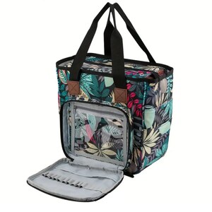 May include: A black and green tote bag with a floral print. The bag has a zippered pocket on the front and a large open pocket on the inside. The bag is open and the inside is visible.