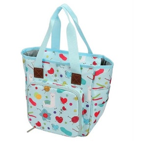 May include: A light blue tote bag with a zippered pocket and a colorful print of llamas, yarn balls, and knitting needles. The bag has two handles and a zipper closure.
