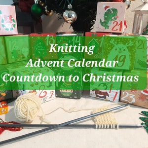 May include: A Knitting Advent Calendar Countdown to Christmas set featuring multiple small, colorful cardboard boxes with holiday illustrations and numbers, accompanied by a ball of cream yarn and two metal knitting needles with a small knitted swatch.