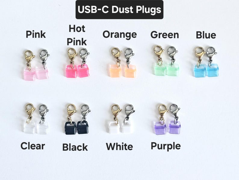 May include: Assortment of USB-C dust plugs in various colors, including pink, hot pink, orange, green, blue, clear, black, white, and purple. Each plug has a small charm attached.