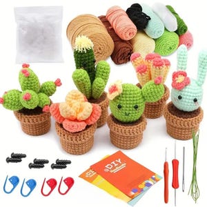May include: A DIY crochet kit featuring various handmade cactus and succulent designs in small brown pots. The kit includes yarn in multiple colors, crochet hooks, stitch markers, and a bag of stuffing. The finished products are green, pink, and yellow.