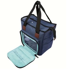 May include: A blue canvas tote bag with a clear plastic window and a zippered pocket. The bag has two black handles and a brown leather accent.