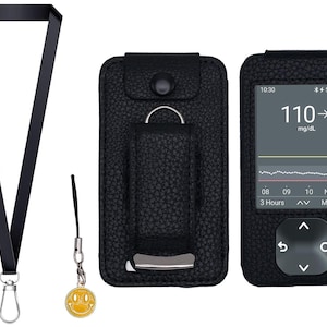 May include: A black leather case with a digital display showing a blood glucose reading of 110 mg/dL. The case has a button and a screen displaying the time, battery life, and a graph. A black lanyard and a yellow smiley face charm are also included.