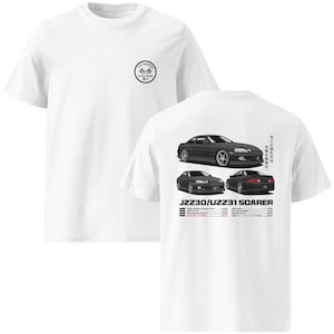 May include: White t-shirt with a crew neck and short sleeves. The front features a small circular logo. The back displays three illustrations of a black car, with text that reads "JZZ30/UZZ31 SOARER".