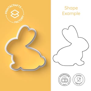 May include: A white plastic cookie cutter in the shape of a rabbit, with a shadow on a yellow background. The cutter is shown next to a line drawing of the same shape. The text "Print & Crafts Factory" is in a circle above the cutter. The text "Shape Example" is above the line drawing. Two circular icons are below the line drawing, one with the text "Dishwasher Safe" and the other with the text "Food Safety".