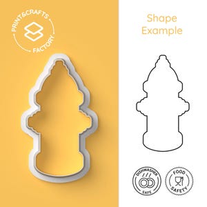 May include: A white plastic fire hydrant cookie cutter with a yellow background. The cutter is in the shape of a fire hydrant. The words "Print & Crafts Factory" are in a circle in the upper left corner. The words "Shape Example" are in the upper right corner.