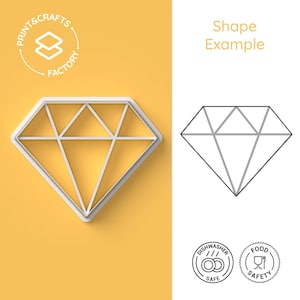 May include: A white plastic diamond-shaped cookie cutter with a line design. The cutter is on a yellow background. The image also shows a black and white line drawing of the cutter, dishwasher safe and food safe icons.