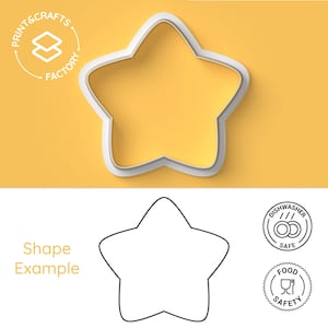 May include: A white star-shaped cookie cutter against a yellow backdrop. The cutter is made of plastic and has a smooth design. The image also includes a black and white outline of the star shape, along with text and icons indicating food safety and dishwasher safety.