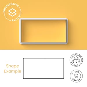 May include: A white plastic cookie cutter in the shape of a rectangle. The cookie cutter is on a yellow background. The cookie cutter is dishwasher and food safe.