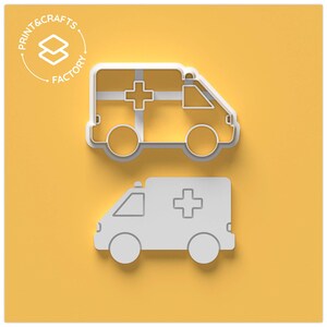 May include: Two white plastic cookie cutters shaped like ambulances. The top cutter has a cross on the side and the bottom cutter has a cross on the roof.
