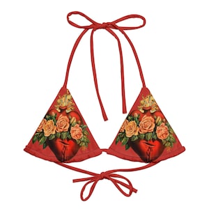 May include: Red triangle bikini top with a floral print featuring a bleeding heart and roses.