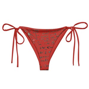 May include: Red bikini bottom with a handwritten script pattern. The bikini bottom has adjustable ties on both sides.