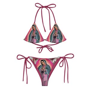 May include: A pink bikini with a triangle top and a cheeky bottom. The fabric features a colorful print of a religious figure.
