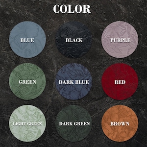 May include: A color chart featuring nine circular swatches with embossed floral patterns. The colors labeled are blue, black, purple, green, dark blue, red, light green, dark green, and brown. Each circle displays a detailed botanical design.
