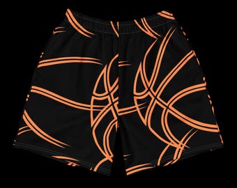 May include: Black basketball shorts with an orange basketball design. The shorts have an elastic waistband and a basketball graphic pattern. The shorts are made of a lightweight material.