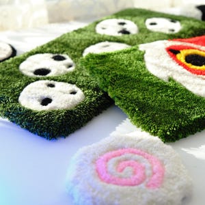 Side angle view showing thickness and width of Mononoke and Kodama tufted keyboard rugs