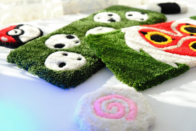 Side angle view showing thickness and width of Mononoke and Kodama tufted keyboard rugs