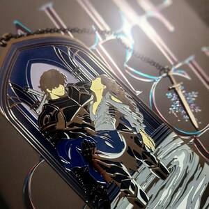 May include: A metal pendant featuring a couple embracing within a gothic arch design. The pendant has a silver finish with blue and black accents. A sword-shaped charm hangs from a chain. The background is dark with iridescent details.