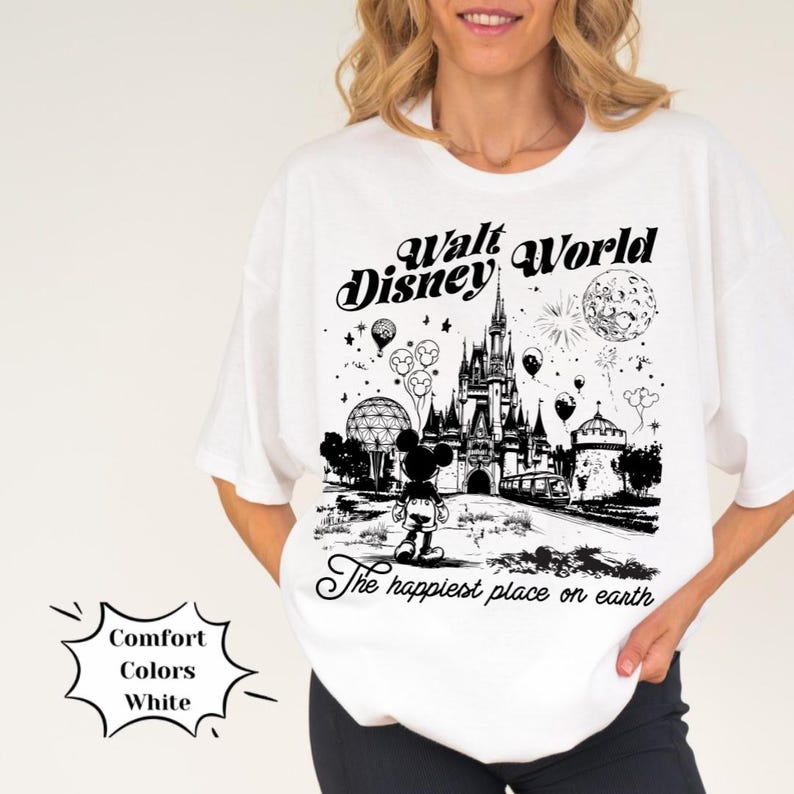 May include: White t-shirt featuring a black and white graphic of the Walt Disney World castle, Mickey Mouse, and the text "Walt Disney World" and "The happiest place on earth".