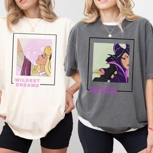 May include: Two t-shirts with different Disney princess designs. The first shirt is ivory with a pink and purple design of Sleeping Beauty with the text "Wildest Dreams". The second shirt is gray with a purple and green design of Maleficent with the text "The fairest of them all".