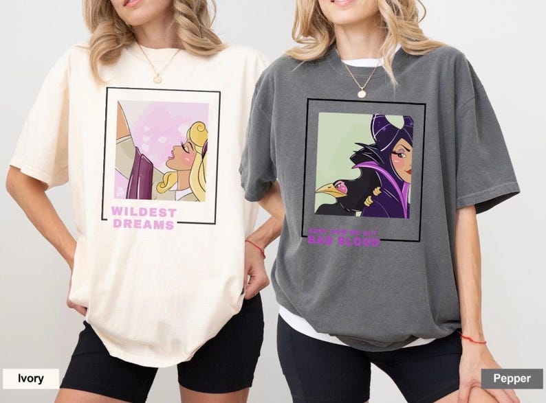 May include: Two t-shirts with different Disney princess designs. The first shirt is ivory with a pink and purple design of Sleeping Beauty with the text "Wildest Dreams". The second shirt is gray with a purple and green design of Maleficent with the text "The fairest of them all".