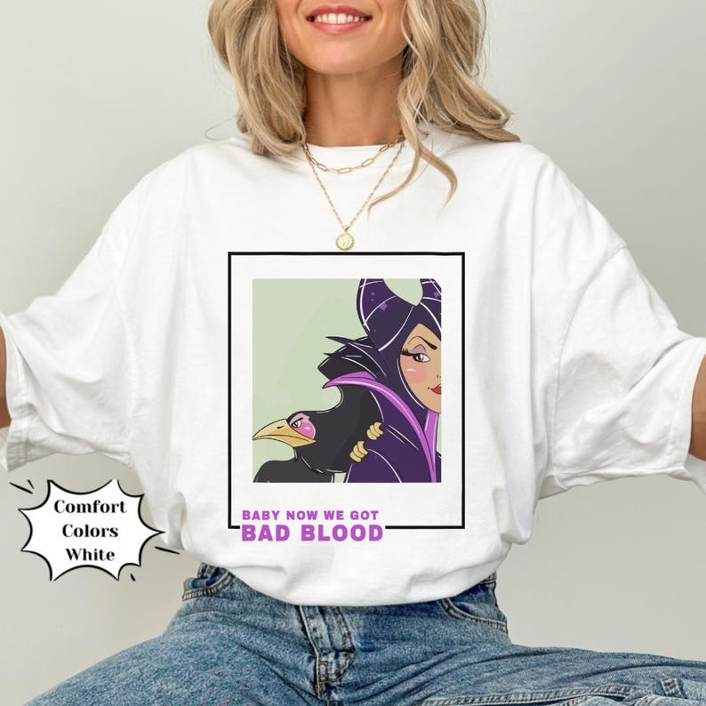 May include: White t-shirt with a graphic of Maleficent from Disney's Sleeping Beauty. The graphic features Maleficent with her raven and the text "Baby now we got bad blood".
