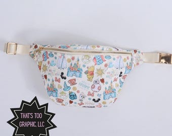 May include: A cream-colored fanny pack with a repeating pattern of cartoon characters, castles, and other whimsical elements. The bag has a gold zipper and buckle, and the text "dreams" is visible. The strap is a light beige color.