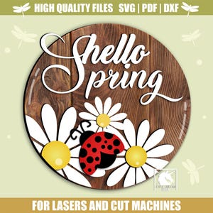 May include: A round wooden sign with the words "Hello Spring" in white script. The sign features white daisies with yellow centers, a red ladybug with black spots, and the text "FOR LASERS AND CUT MACHINES".